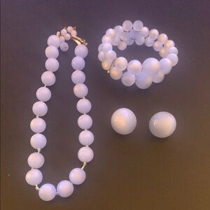 Hold 4 ROBOCON70 Blue acrylic moon glow jewelry set.